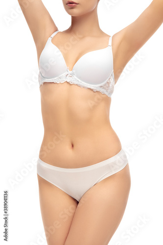 Beautiful female belly isolated on white background. Beauty, cosmetics, spa, depilation, treatment and fitness concept. Fit and sportive, sensual body with well-kept skin in underwear.