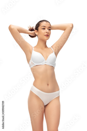 Beautiful female model isolated on white background. Beauty, cosmetics, spa, depilation, diet and treatment and fitness concept. Fit and sportive, sensual body with well-kept skin in underwear. © master1305