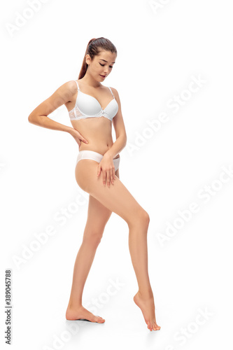 Beautiful female model isolated on white background. Beauty, cosmetics, spa, depilation, diet and treatment and fitness concept. Fit and sportive, sensual body with well-kept skin in underwear.