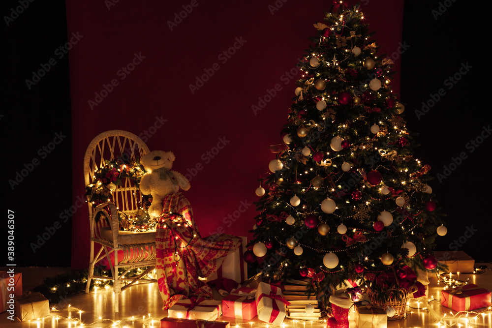 Light garlands of Christmas tree decor presents new year night interior
