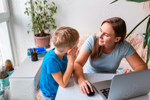 Mother with kid working from home during quarantine. Stay at home, work from home concept during coronavirus pandemic
