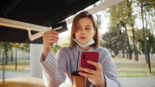 Woman shopping online on a sunny day with credit card. Online banking with smart phone. Easy pay using smart phone. Communication via app for sale in shop. photo