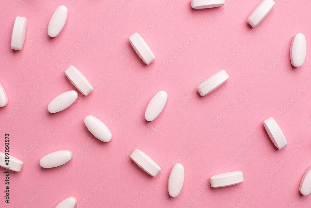 White vitamin pills to raise immunity on pink background, health and medical White vitamin pills to raise immunity on pink background, health and medical