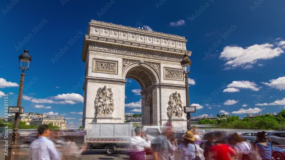 The Arc de Triomphe (Triumphal Arch of the Star) timelapse hyperlapse with traffic on circle road and trees around. Famous monument in Paris, standing at the western end of the Champs-Elyseees. Blue