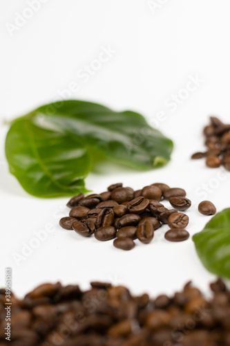 coffee beans and leaves on white background