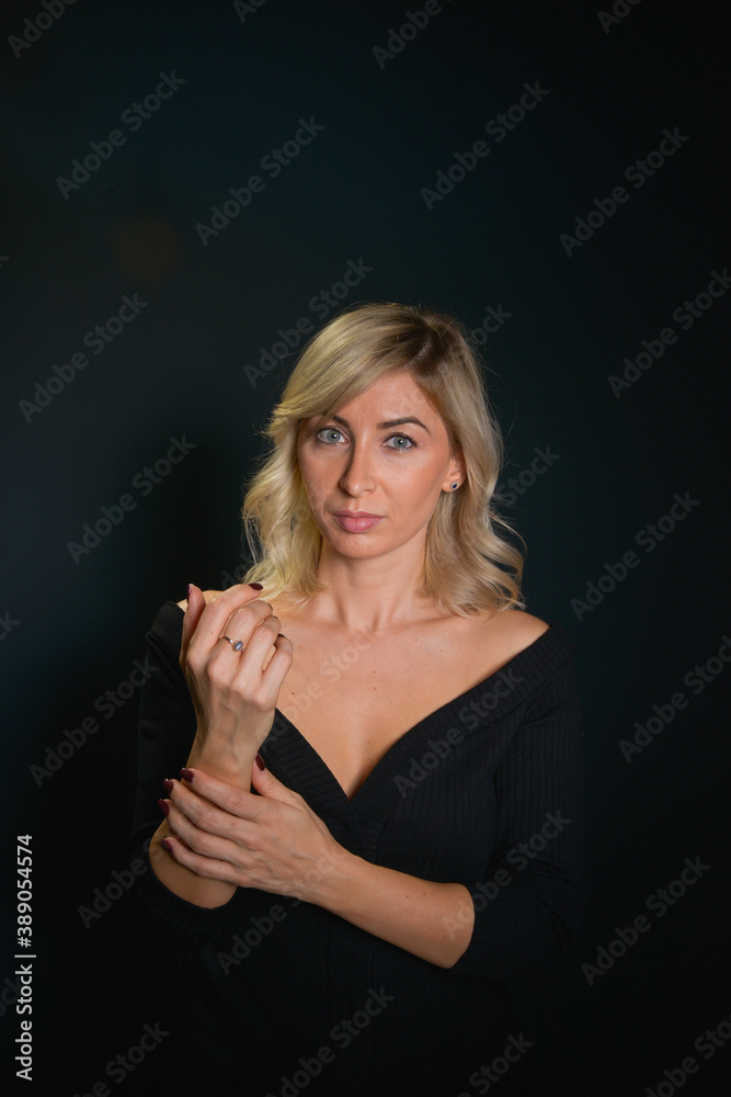 Beautiful young blonde woman with blue eyes isolated on back 
