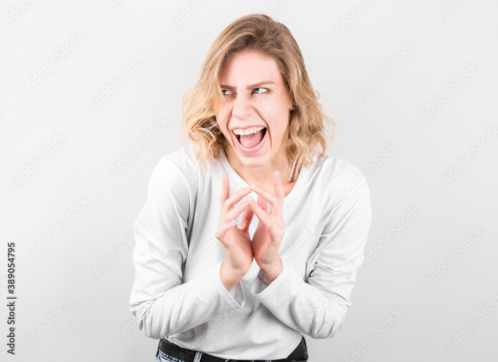 Crazy funny female crying, makes grimace, foolishes, isolated over gray background. Facial expressions. Childish woman going crazy. Crazy funny female crying, makes grimace, foolishes, isolated over gray background. Facial expressions. Childish woman going crazy.