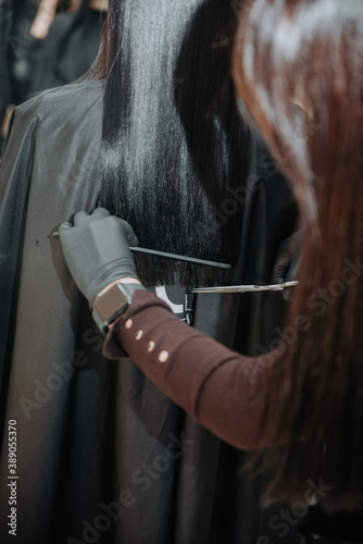 Young beautiful woman having her hair cut at the hairdresser's.