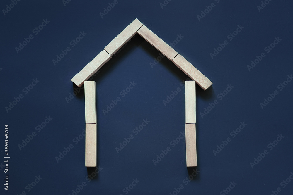 house from wooden blocks on a blue background, the concept of buying, selling, renting real estate, building and house design, eco style house from wooden blocks on a blue background, the concept of buying, selling, renting real estate, building and house design, eco style