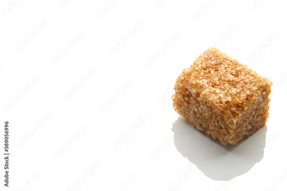 Pieces of natural brown sugar on a white background. copy space Pieces of natural brown sugar on a white background. copy space
