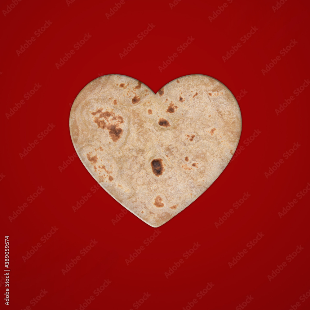 Fototapeta premium roti or Ruti in shape of a heart on white background. Flat lay. Love concept. isolated, Valentine's day background. Flat lay, top view, template, copy space, minimal idea concept.14 February, food