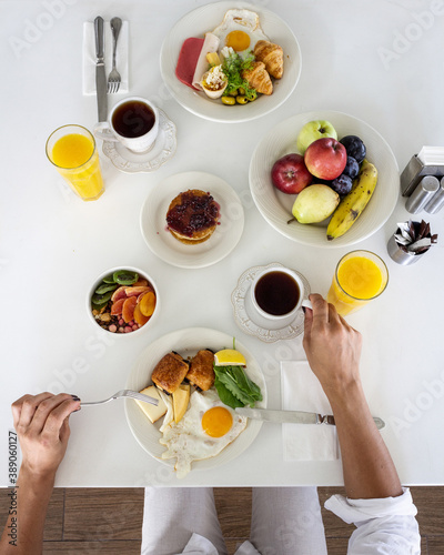  Healthy beautiful morning breakfast with organic and natural fruits on a white table at the hotel. food and drink vacation concept