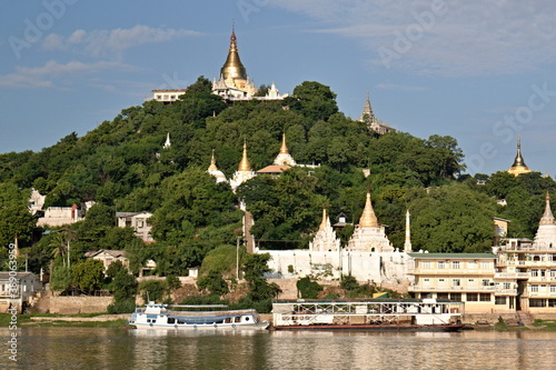 View of the Sagaing Pagoda while sailing along the Irrawaddy River. Myanmar. Asia.