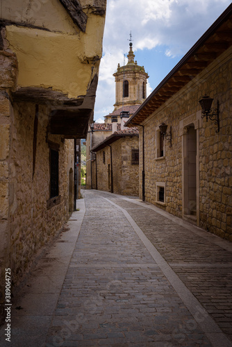 Street of Santo Domingo de Silos with the tower of Monastery of SIlos in the background, Burgos, Spain