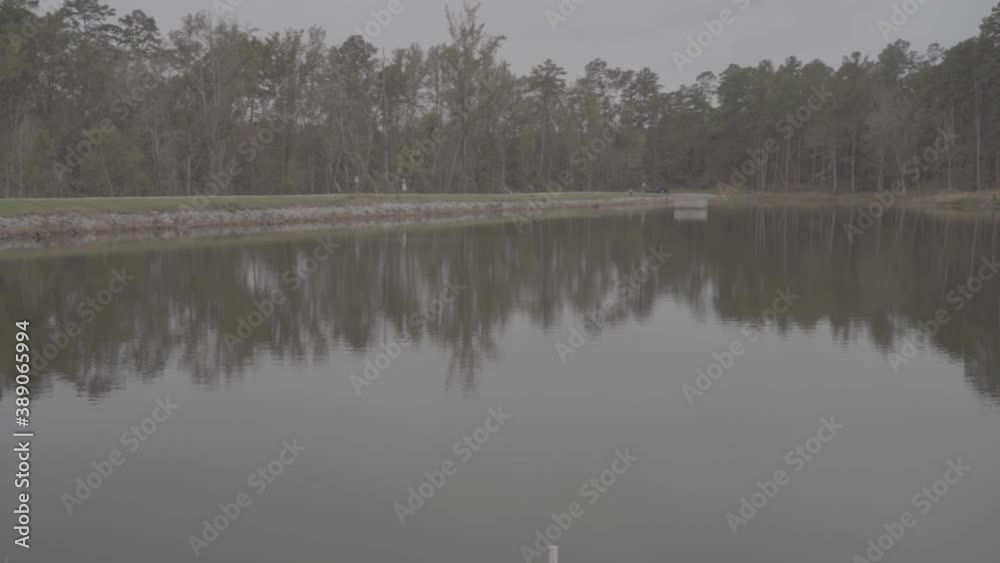 Slow left to right pan of a calm, peaceful lake and opposite shoreline on a fall morning. Slow left to right pan of a calm, peaceful lake and opposite shoreline on a fall morning.