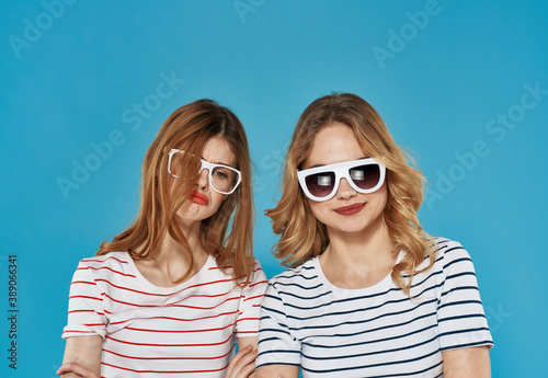 two cheerful girlfriends in striped t-shirts sunglasses hug friendship  © SHOTPRIME STUDIO