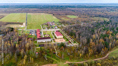 Top view of the autumn forest. The Volga river in the Staritsky district of the Tver region, Russia. Manor and village. photo