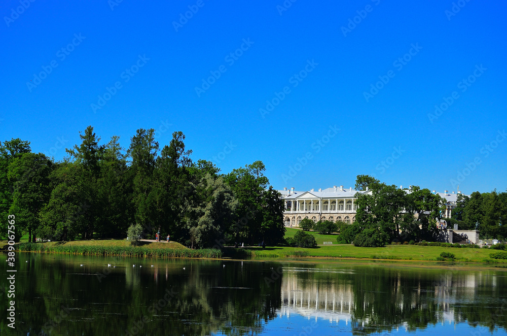 Scenery. View of the Cameron Gallery from the Big Pond with reflection in the water and blue sky. Russia, Saint Petersburg, 08/17/2020