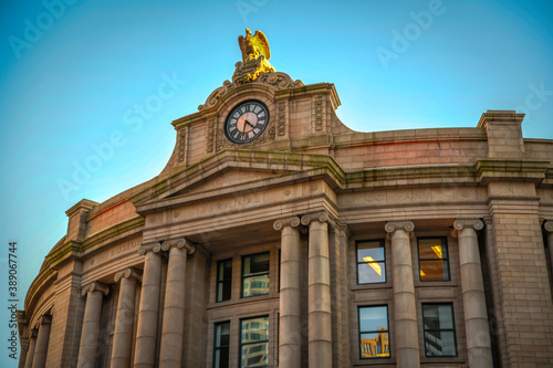 The clock and facade of South Station in downtown Boston photo