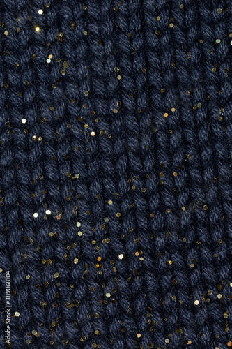 close up macro of blue wool sweater with gold glitter