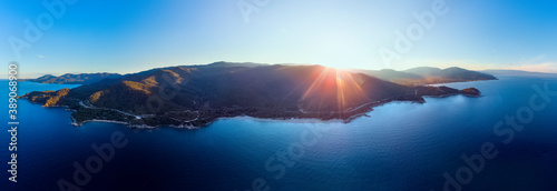 Fototapeta Naklejka Na Ścianę i Meble -  Drone panorama of sunset in Halkidiki with blue sea and mountains