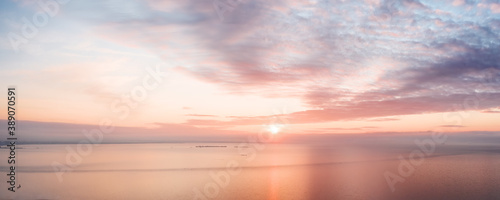 Calm pink colored sea and sky at sunset