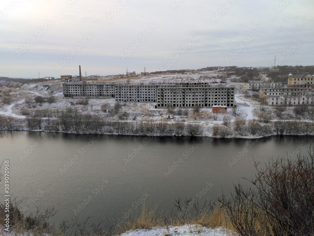 warm winter on the river Bank with a view of the village of North Russia