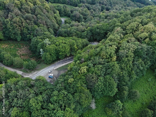 Aerial view over agricultural fields and road. Dark clouds in the sky