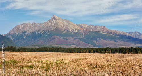 Mount Krivan peak (Slovak symbol) wide panorama with autumn harvested field in foreground, Typical autumnal scenery of Liptov region, Slovakia
