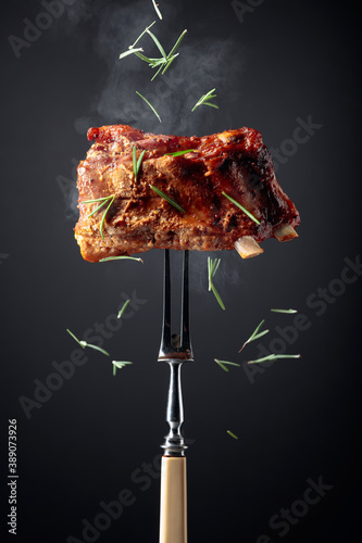 Grilled pork ribs on a fork.