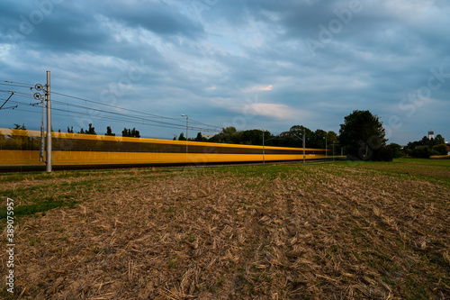 Long-term exposure of a yellow streetcar during twilight. photo