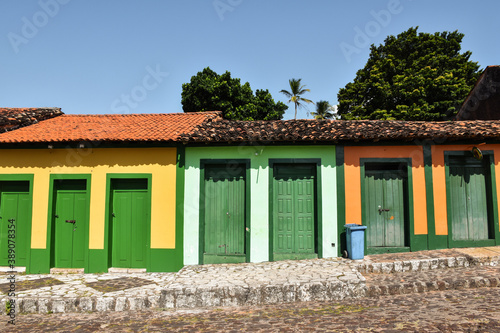 Cobbled street and the facade of some charming colorful colonial buildings, in the historic center. Alcântara, Maranhão, Brazil. photo