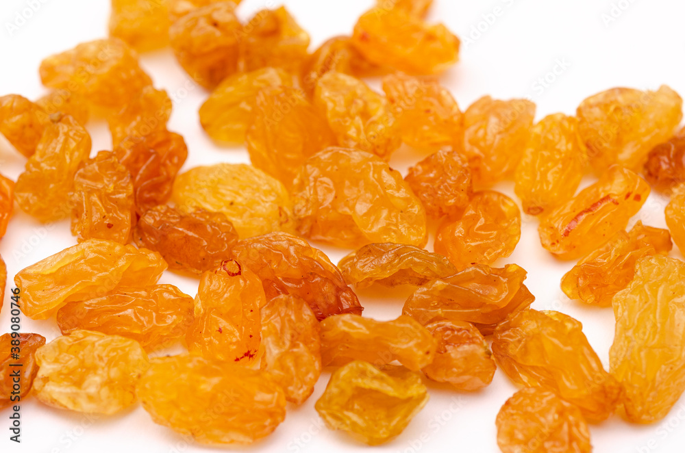Handful of appetizing yellow raisins on a white background Handful of appetizing yellow raisins on a white background