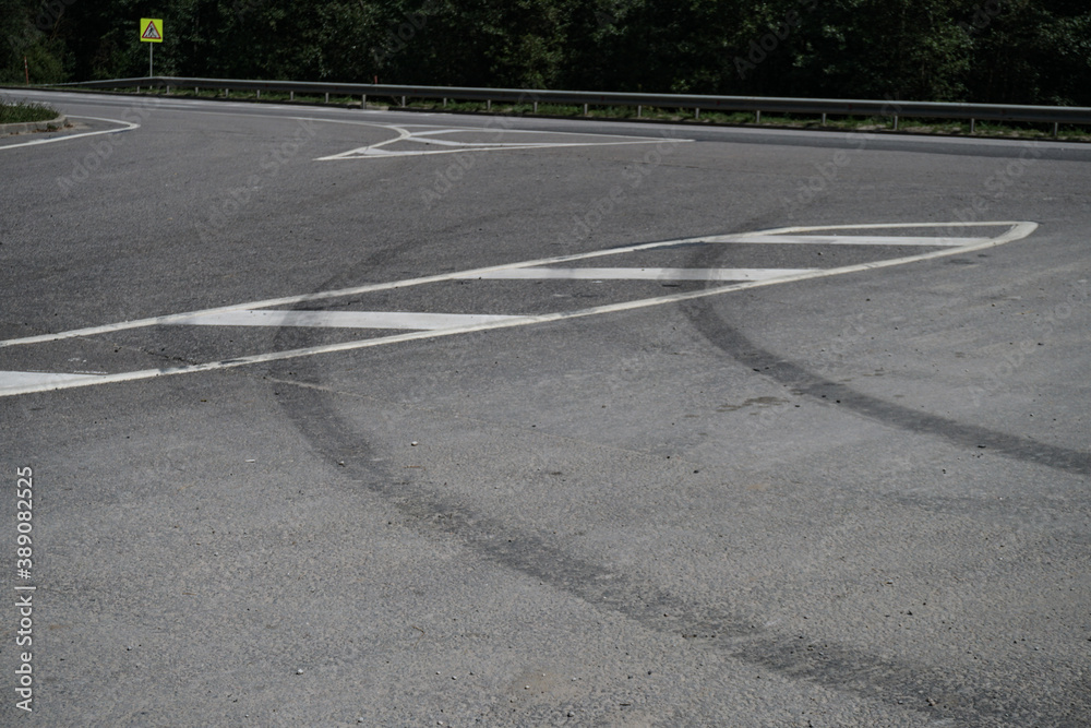 Tire marks on the asphalt. Good brakes and correct distance from the vehicle. Car safety theme