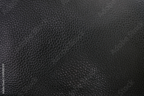 Black natural leather, close-up, isolated background for design
