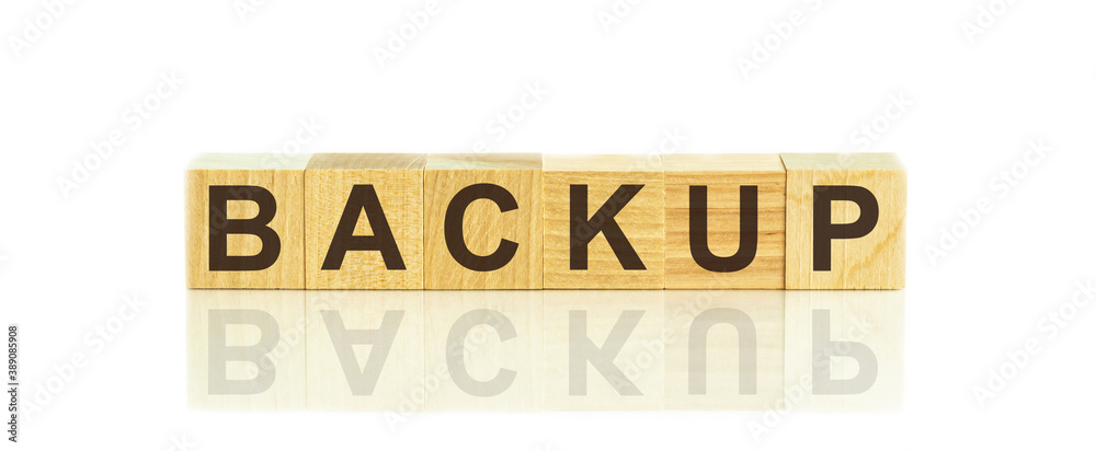 Wooden Blocks with the text: backup. The text is written in black letters and is reflected in the mirror surface of the table. Wooden Blocks with the text: backup. The text is written in black letters and is reflected in the mirror surface of the table.