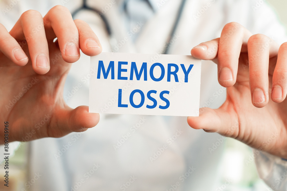 Doctor holding a card with text MEMORY LOSS Doctor holding a card with text MEMORY LOSS