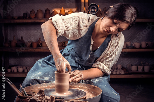 Stylish potter master woman enjoying pottery art and production process. Handicraft.