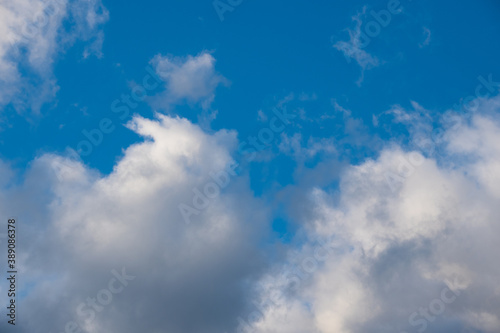 Blue sky background with white dramatic clouds and sunlight  sky background