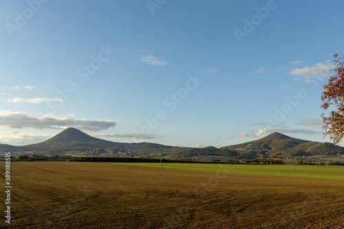 autum czech nature in central range with mountains and ploughed field photo