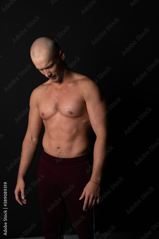 Handsome power athletic man in training pumping up muscles with dumbbell. Strong bodybuilder with six pack, perfect abs, shoulders, biceps, triceps and chest. Image with Handsome power athletic man in training pumping up muscles with dumbbell. Strong bodybuilder with six pack, perfect abs, shoulders, biceps, triceps and chest. Image with