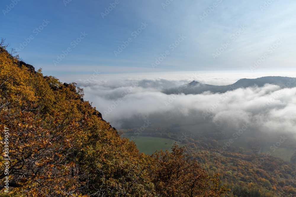 Autumn mountains with clouds in valley