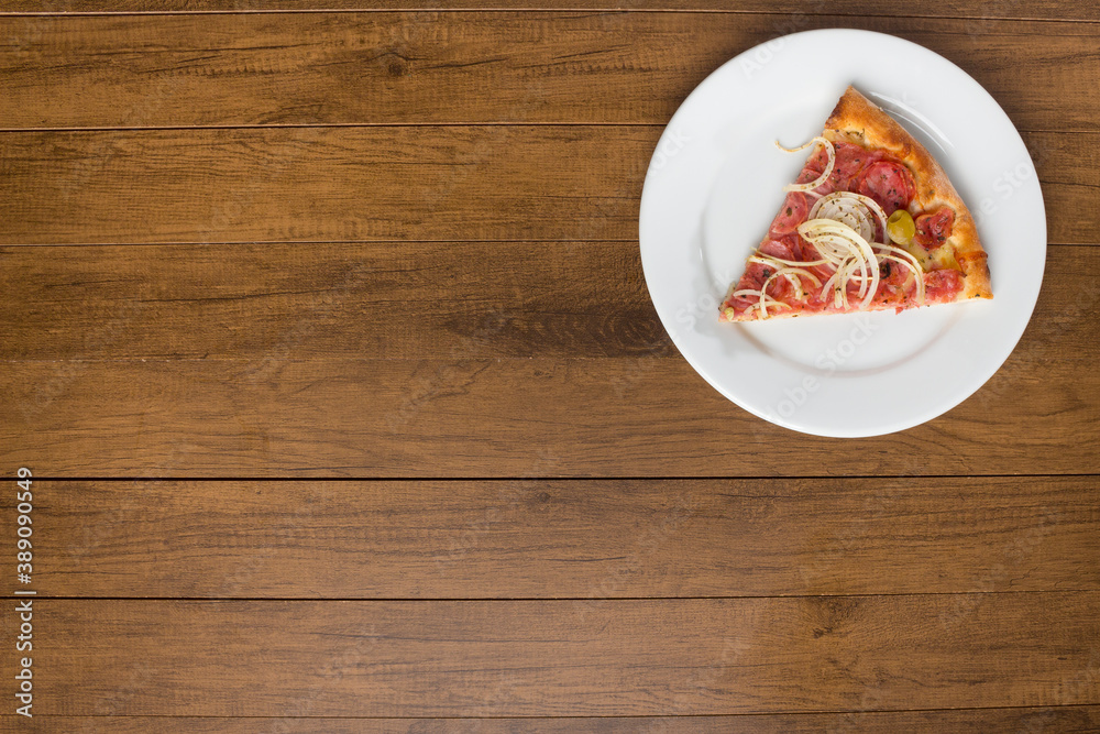 Pepperoni Pizza slice made with slices of onions, mozzarella cheese and green olives. Top gastronomic photography with left space for texts. Pepperoni Pizza slice made with slices of onions, mozzarella cheese and green olives. Top gastronomic photography with left space for texts.