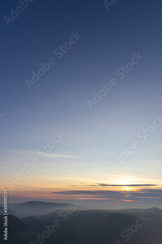 Autumn sunset above foggy hills