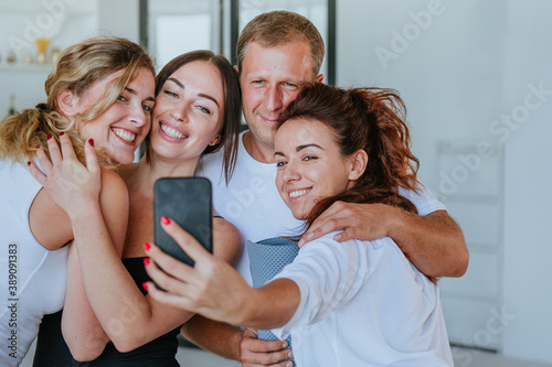 Smiling young people having fun making selfie photo
