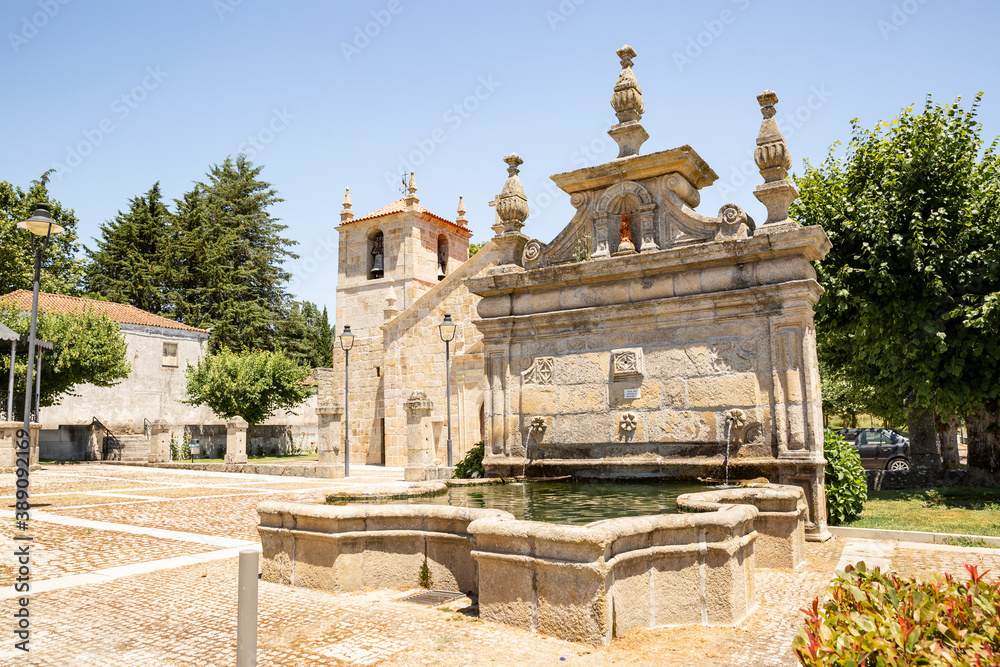 Saint Francis water fountain and the Parish church in Vila da Rua town, municipality of Moimenta da Beira, district of Viseu, Portugal