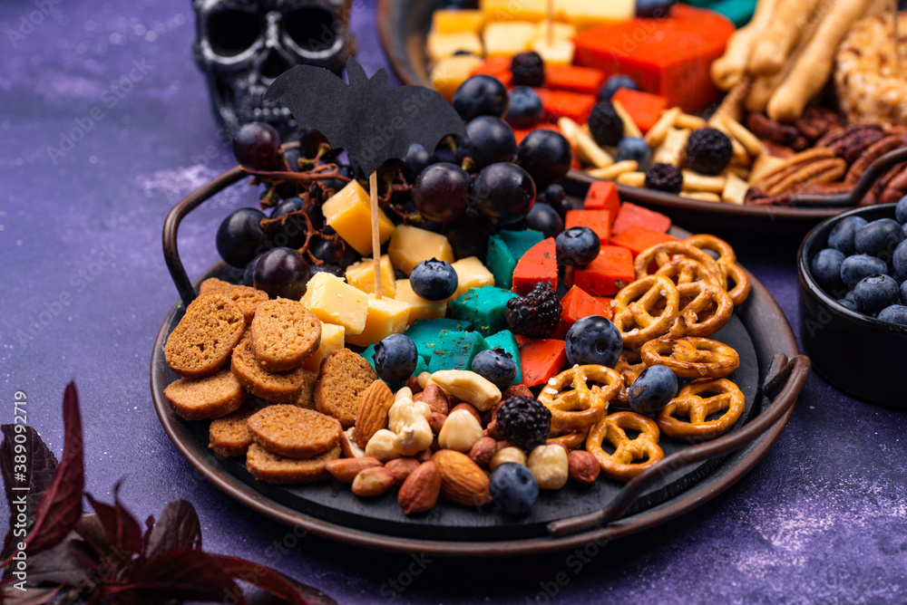 Halloween appetizers. Cheese plate with snacks