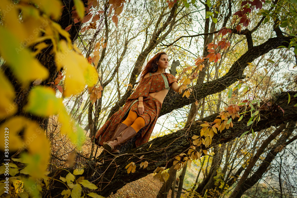 Woman on a tree autumn background