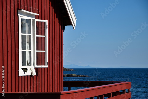 Red Norway house at the seaside. © Marcin