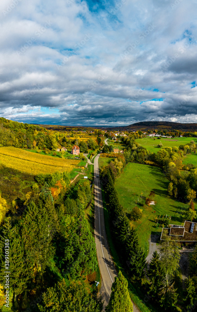 A drone rises above a multi-colored valley in the Vosges.